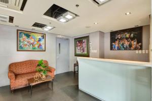 a waiting room with a couch and a table at CEO Flats in Manila +60 photos