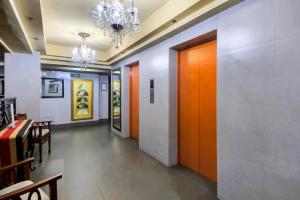 a corridor of a restaurant with orange doors and tables at CEO Flats in Manila