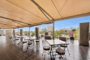a patio with tables and chairs and a view of the city at CEO Flats in Manila