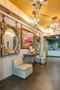 a room with a table and a chair and mirrors at CEO Flats in Manila