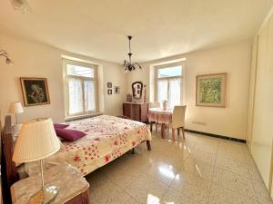 a bedroom with a bed and a table and chairs at Vida Boa - Holiday Residence in Nago-Torbole