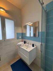 a bathroom with a sink and a glass shower at House Pale Rooms in Palau +18 photos