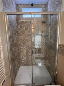 a shower with a glass door in a bathroom at House Pale Rooms in Palau