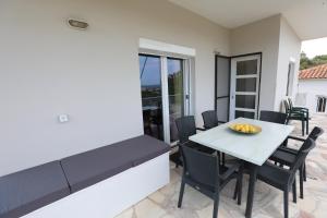 a dining room with a white table and chairs at Kydonies House in Skála Néon Kydonión