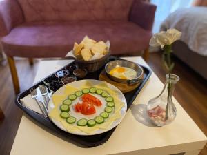 a tray with a plate of food on a table at Konak Akaretler Suit in Istanbul