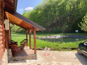 a porch of a house with a view of a river at Vajat Tuk in Bajina Bašta