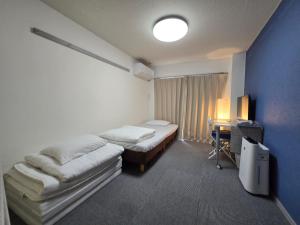 Ένα ή περισσότερα κρεβάτια σε δωμάτιο στο エバグリーンヴィラ太秦203さくら