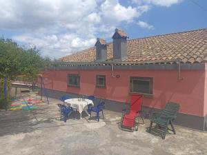 a patio with a table and chairs in front of a house at Casa Agrumeto in Nunziata in Nunziata