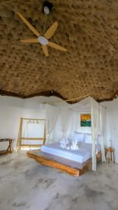 a bedroom with a bed with a wooden ceiling at Balihao Resort in Mambajao +117 photos