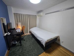 Ένα ή περισσότερα κρεβάτια σε δωμάτιο στο エバグリーンヴィラ太秦206もみじ