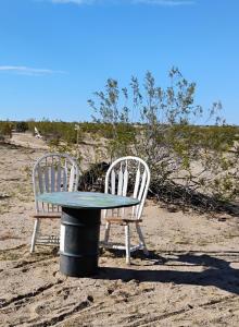 two chairs and a table in the sand with a table at Simply Camping in Hidden River +7 photos