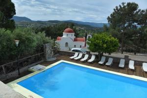 a villa with a swimming pool and a house at PETRINO Hotel in Mythimna