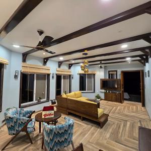 a living room with a couch and a tv at Sea Breeze, Guhagar in Guhagar +37 photos