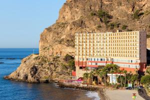 a hotel on a cliff next to the ocean at Mirador del Cabo Designed For Adults in Aguadulce
