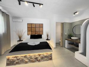 a bedroom with a large bed and a bathroom at LA Casa Di Lusso Casa N2 Adults Only in Kolimbia