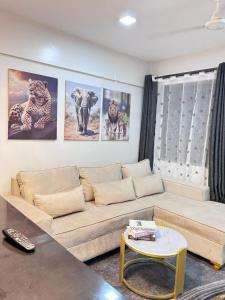 a living room with a couch and pictures on the wall at Mima homes in Gatunga