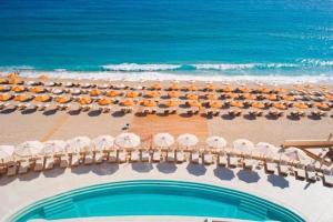 an aerial view of a beach with umbrellas and the ocean at Konstantinos Palace in Karpathos