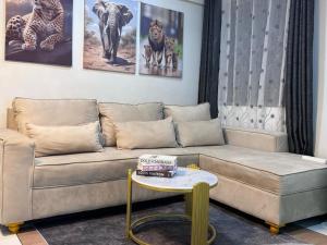 a living room with a couch and a table at Mima homes in Gatunga