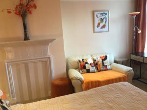 a living room with a couch and a chair at Arun Sands Rooms in Littlehampton