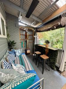 a porch with a bed and a table and a table at Indys Place in Bright