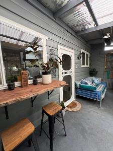 a room with a table and chairs and a couch at Indys Place in Bright +16 photos