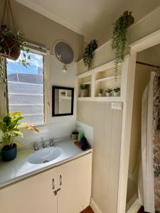 a bathroom with a sink and a window at Indys Place in Bright