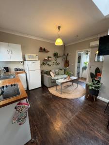 a kitchen and living room with a white refrigerator at Indys Place in Bright
