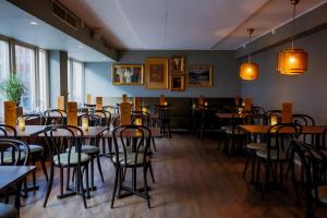 a room with tables and chairs in a restaurant at Home Hotel Cardinal in Växjö