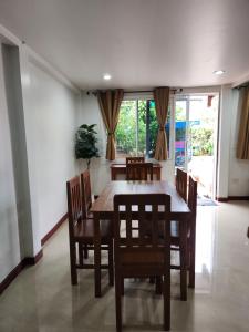 a dining room with a wooden table and chairs at Sabai - Sabai in Bangkok