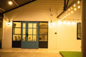 an open garage with a blue door and lights at Runway Tail 145 in Sathani Lat Krabang