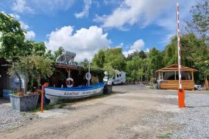 a blue boat parked in front of a building at Бунгало HAKUNA MATATA, Къмпинг Созопол Еко, плаж Градина in Sozopol