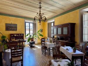 a restaurant with tables and chairs and a chandelier at 44 - Mu Ni in Amelia