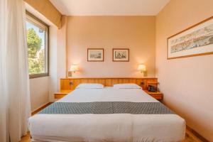 Postel nebo postele na pokoji v ubytování Crystal Hotel Varese