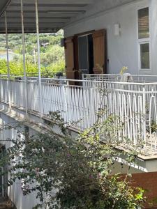 a white balcony of a house with flowers at La Casa di Rorò in Sperlonga