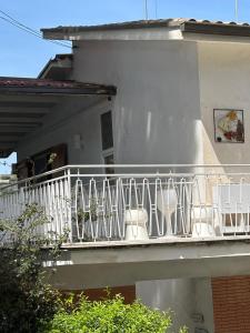 a balcony with potted plants on a house at La Casa di Rorò in Sperlonga +41 photos