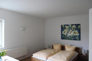 Ein Bett oder Betten in einem Zimmer der Unterkunft Gästehaus Glaubenstein
