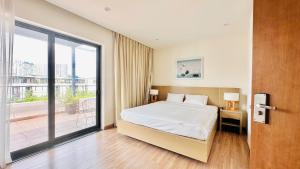 a bedroom with a bed and a large window at Villa 102 - villa 114 royal lotus, Hùng Thắng, Hạ Long, Quảng Ninh in Ha Long +56 photos