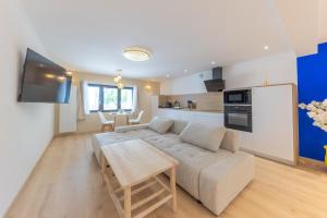 a living room with a couch and a table at L'Andalouse - SPA Privatif - Jacuzzi Hammam Sauna in Mittelhausbergen +29 photos