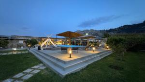 a patio with a table and chairs and a pool at LA Casa Di Lusso N7 -Adults Only in Kolymbia +22 photos