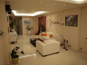 a living room with a white couch and a table at Konstantinos Palace in Karpathos