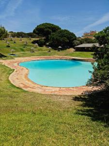 a large pool of water in a field at Albur Beach House in Alvor