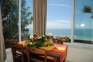 a dining room table with a view of the ocean at Casette in riva al mare Ale e Manu in Latte