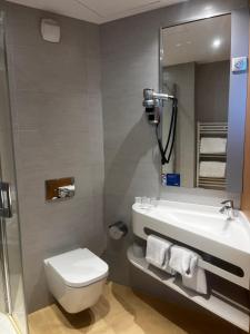 a bathroom with a toilet and a sink and a mirror at SoBlue Hôtel in Antibes