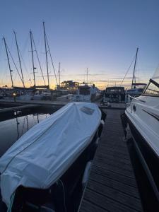 a group of boats docked at a dock with a tarp on them at Sopot Classic Boat in Sopot +20 photos