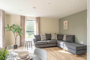 a living room with a couch and a table at Maple Apartments - Modern 2 Bed Apartment in Derby in Derby +29 photos