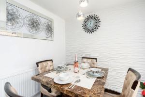 a dining room with a table and chairs at Charming 3 Bedroom Home with Garden near Doncaster in Doncaster