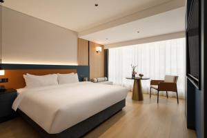 Postelja oz. postelje v sobi nastanitve Chongqing Jiefangbei Jiayu Hotel