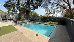 a swimming pool in the backyard of a house at The Bolton Rosebank in Johannesburg