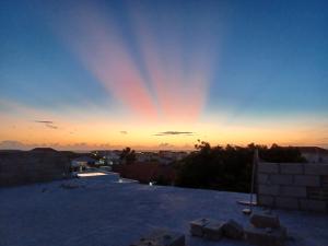 a rainbow in the sky at sunset on a roof at Flamingo Apartment - Regal Rentals Curacao in Willemstad +2 photos