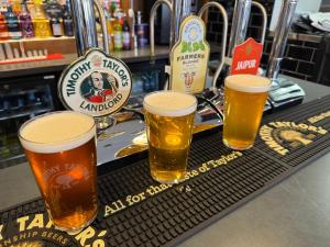 a tray with four glasses of beer on a bar at SPIRE VIEW at THE SPREAD EAGLE in Chesterfield